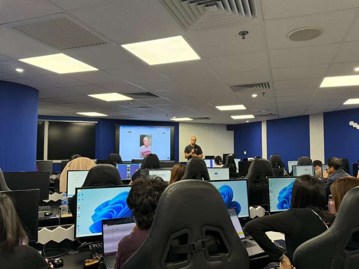 Ivan So delivering AI training in computer lab for corporate team